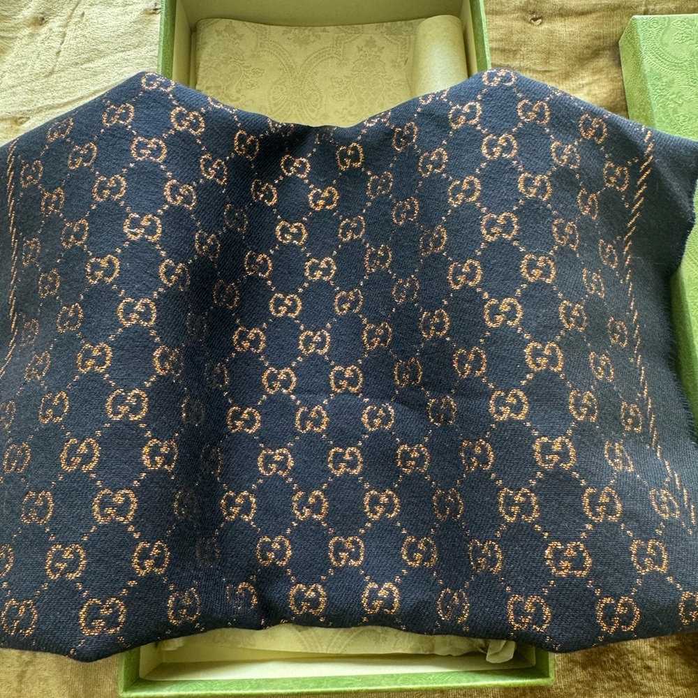 Gucci Navy Blue wool scarf with metallic copper GG monogram.